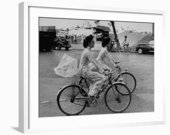 Women Riding Bicycles in Saigon-John Dominis-Framed Photographic Print