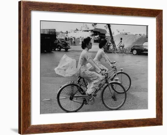 Women Riding Bicycles in Saigon-John Dominis-Framed Photographic Print