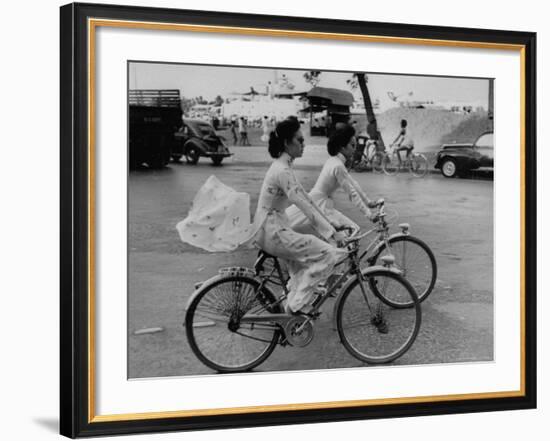 Women Riding Bicycles in Saigon-John Dominis-Framed Photographic Print