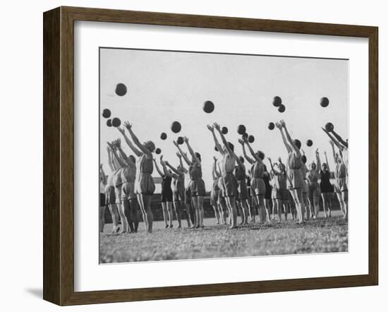 Women's Gym Class with Rows of Women Throwing Balls Into Air in Unison-null-Framed Photographic Print