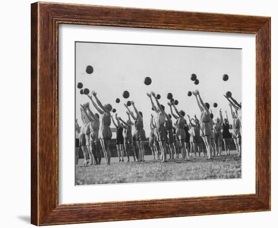 Women's Gym Class with Rows of Women Throwing Balls Into Air in Unison-null-Framed Photographic Print