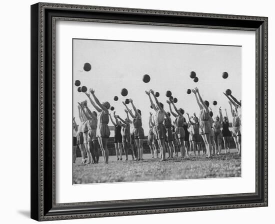 Women's Gym Class with Rows of Women Throwing Balls Into Air in Unison-null-Framed Photographic Print