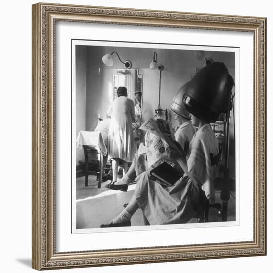 Women Sitting under Hair Dryers at the Hairdressers-Henry Grant-Framed Photographic Print