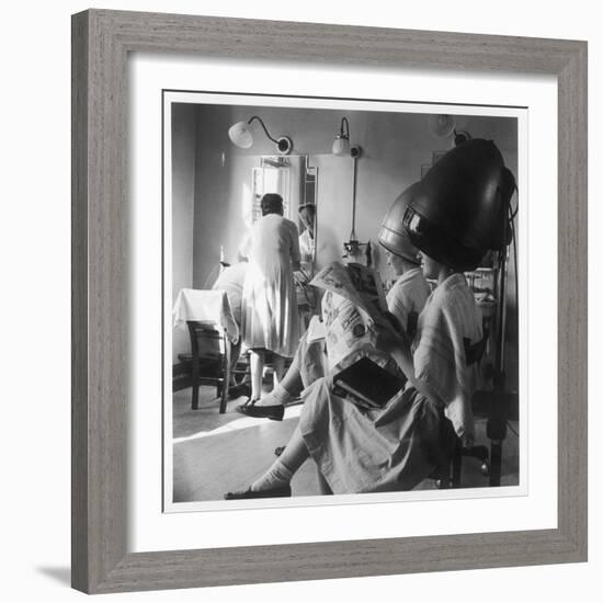 Women Sitting under Hair Dryers at the Hairdressers-Henry Grant-Framed Photographic Print