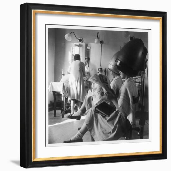 Women Sitting under Hair Dryers at the Hairdressers-Henry Grant-Framed Photographic Print