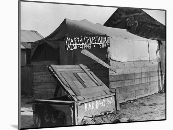 Wooden and Tin Shack with Canvas Roof Housing, Mary Ely Restaurant, Bar B Q Today, in Oil Boomtown-Carl Mydans-Mounted Photographic Print