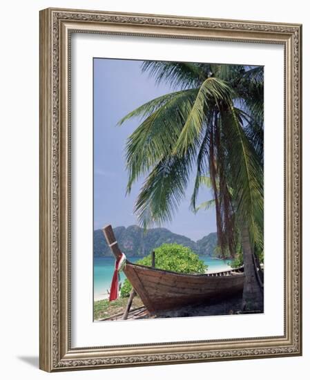 Wooden Boat Beneath Palm Trees on Beach, off the Island of Phuket, Thailand-Ruth Tomlinson-Framed Photographic Print