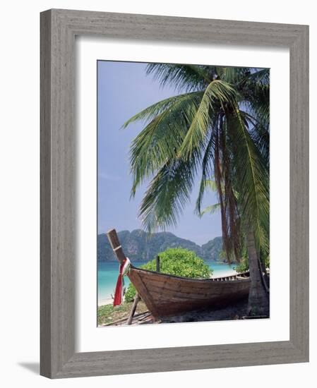 Wooden Boat Beneath Palm Trees on Beach, off the Island of Phuket, Thailand-Ruth Tomlinson-Framed Photographic Print