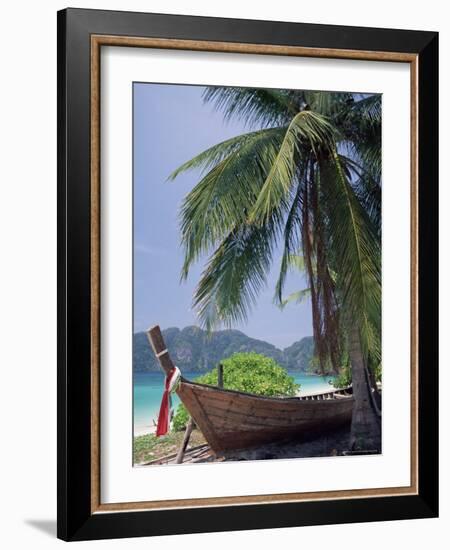 Wooden Boat Beneath Palm Trees on Beach, off the Island of Phuket, Thailand-Ruth Tomlinson-Framed Photographic Print