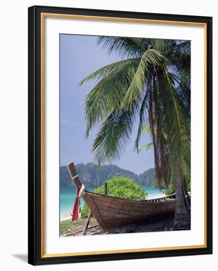 Wooden Boat Beneath Palm Trees on Beach, off the Island of Phuket, Thailand-Ruth Tomlinson-Framed Photographic Print