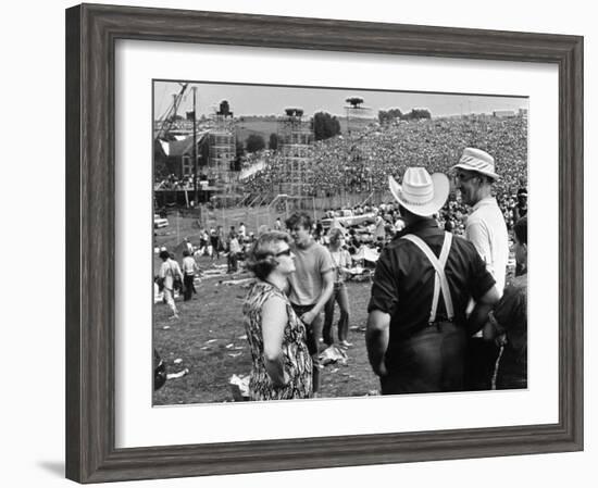 Woodstock, Farmer Max Yasgur Looks On As His Grounds Are Used For Woodstock Festival, 1970-null-Framed Photo