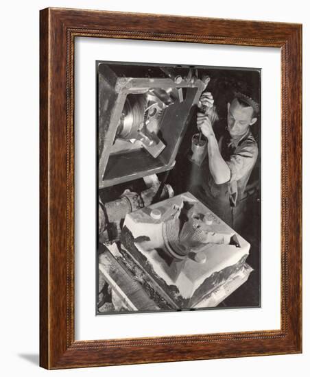 Worker Finishing Sand Mold for an Air-Cooled Airplane Cylinder Head, Aluminum Co. Factory-Margaret Bourke-White-Framed Photographic Print