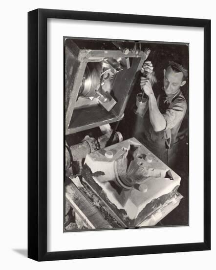 Worker Finishing Sand Mold for an Air-Cooled Airplane Cylinder Head, Aluminum Co. Factory-Margaret Bourke-White-Framed Photographic Print