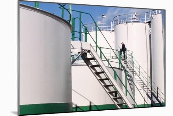 Worker Inspecting An Oil Storage Tank-Geoff Tompkinson-Mounted Photographic Print