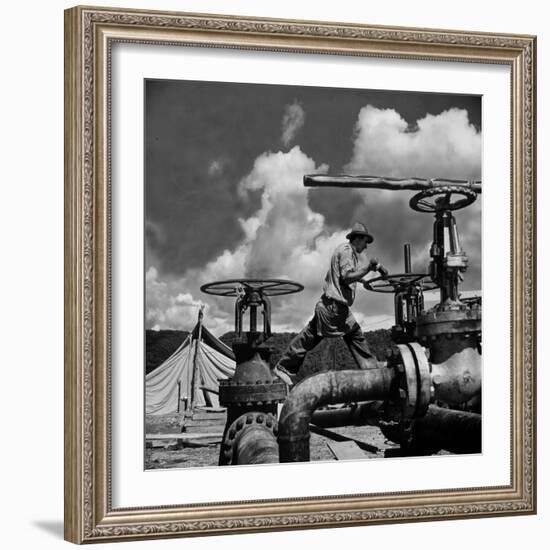 Worker Opening up a Pipeline to Let the Oil Flow-Thomas D^ Mcavoy-Framed Photographic Print