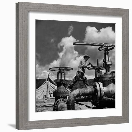 Worker Opening up a Pipeline to Let the Oil Flow-Thomas D^ Mcavoy-Framed Photographic Print