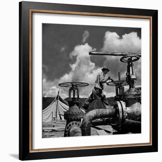 Worker Opening up a Pipeline to Let the Oil Flow-Thomas D^ Mcavoy-Framed Photographic Print