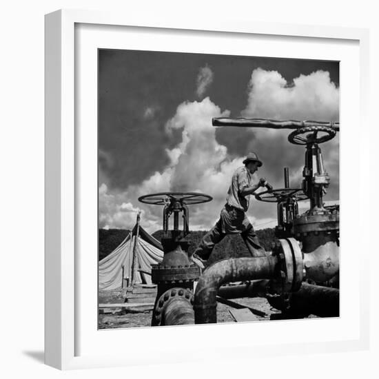 Worker Opening up a Pipeline to Let the Oil Flow-Thomas D^ Mcavoy-Framed Photographic Print