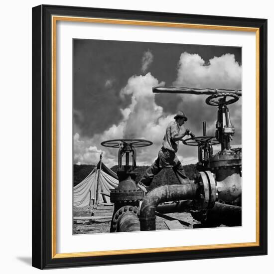 Worker Opening up a Pipeline to Let the Oil Flow-Thomas D^ Mcavoy-Framed Photographic Print