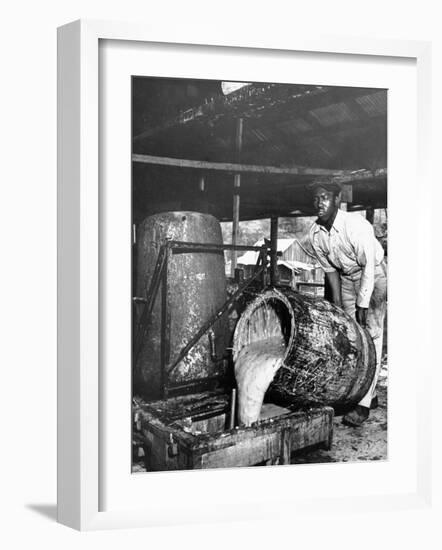 Worker Pouring Gum from Pine Trees into a Still During Turpentine Production-Hansel Mieth-Framed Photographic Print