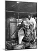 Worker Pouring Gum from Pine Trees into a Still During Turpentine Production-Hansel Mieth-Mounted Photographic Print