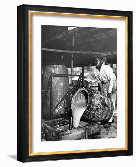 Worker Pouring Gum from Pine Trees into a Still During Turpentine Production-Hansel Mieth-Framed Photographic Print