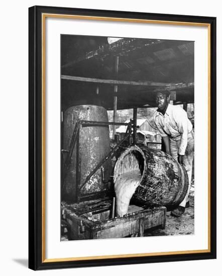 Worker Pouring Gum from Pine Trees into a Still During Turpentine Production-Hansel Mieth-Framed Photographic Print