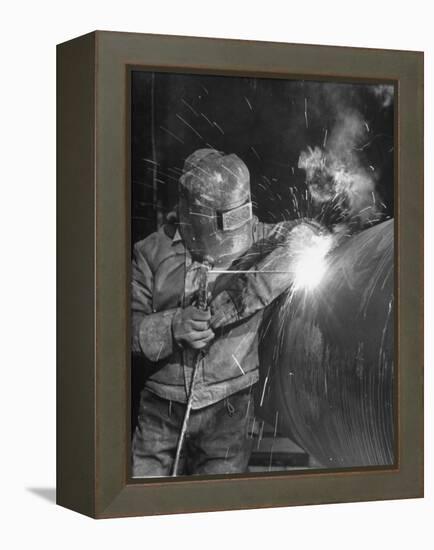 Worker Welding Pipe Used in Natural Gas Pipeline at World's Biggest Coal Fueled Generating Plant-Margaret Bourke-White-Framed Premier Image Canvas