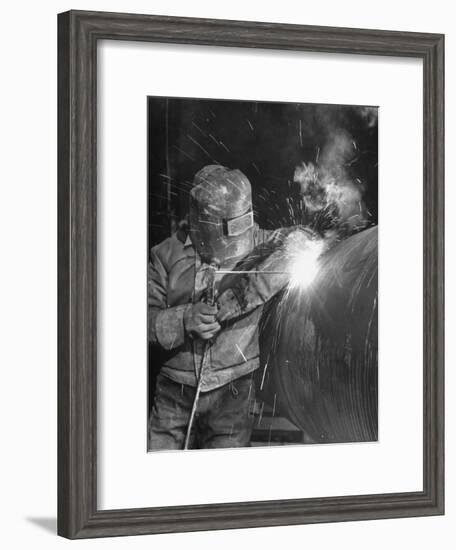 Worker Welding Pipe Used in Natural Gas Pipeline at World's Biggest Coal Fueled Generating Plant-Margaret Bourke-White-Framed Premium Photographic Print