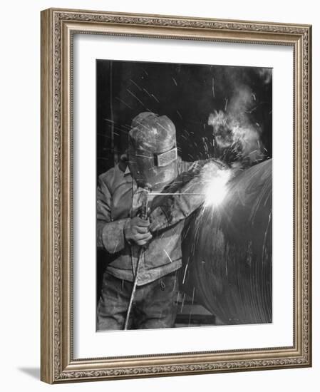 Worker Welding Pipe Used in Natural Gas Pipeline at World's Biggest Coal Fueled Generating Plant-Margaret Bourke-White-Framed Photographic Print
