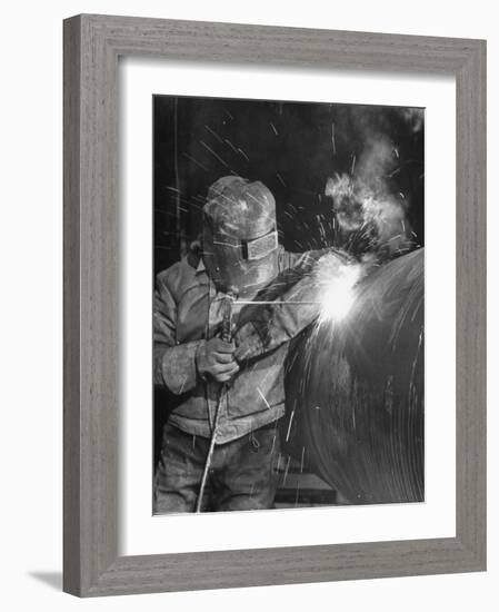 Worker Welding Pipe Used in Natural Gas Pipeline at World's Biggest Coal Fueled Generating Plant-Margaret Bourke-White-Framed Photographic Print