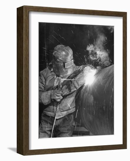 Worker Welding Pipe Used in Natural Gas Pipeline at World's Biggest Coal Fueled Generating Plant-Margaret Bourke-White-Framed Photographic Print