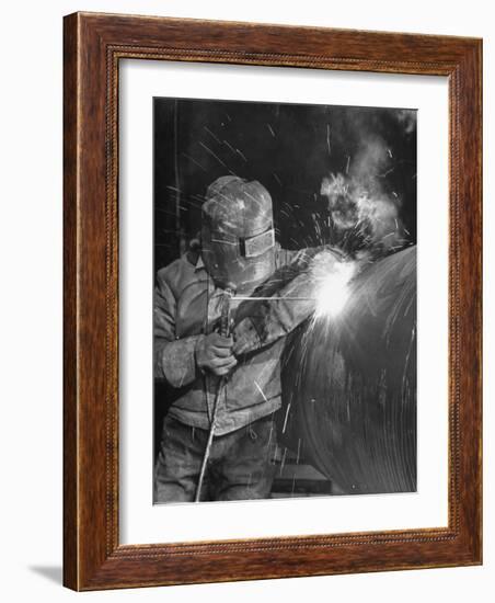 Worker Welding Pipe Used in Natural Gas Pipeline at World's Biggest Coal Fueled Generating Plant-Margaret Bourke-White-Framed Photographic Print