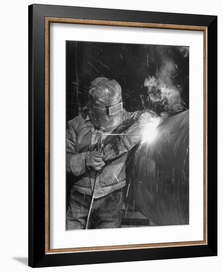 Worker Welding Pipe Used in Natural Gas Pipeline at World's Biggest Coal Fueled Generating Plant-Margaret Bourke-White-Framed Photographic Print