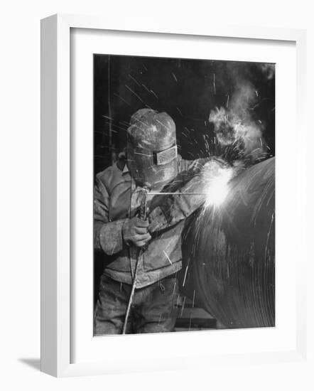 Worker Welding Pipe Used in Natural Gas Pipeline at World's Biggest Coal Fueled Generating Plant-Margaret Bourke-White-Framed Photographic Print