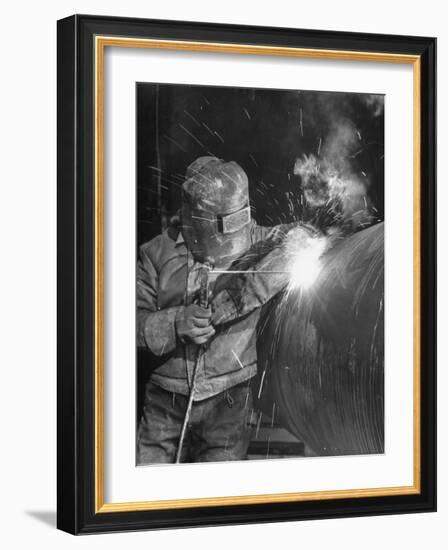 Worker Welding Pipe Used in Natural Gas Pipeline at World's Biggest Coal Fueled Generating Plant-Margaret Bourke-White-Framed Photographic Print