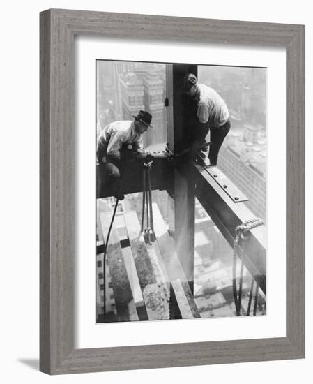 Workers balancing on steel beam above streets during construction of the Manhattan Company Building-Arthur Gerlach-Framed Photographic Print