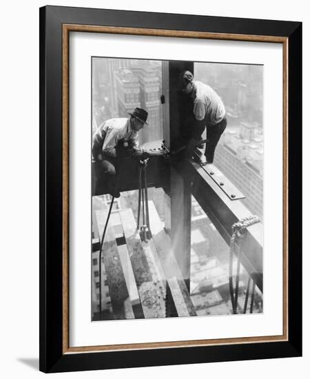 Workers balancing on steel beam above streets during construction of the Manhattan Company Building-Arthur Gerlach-Framed Photographic Print