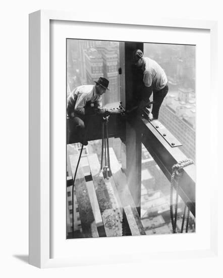 Workers balancing on steel beam above streets during construction of the Manhattan Company Building-Arthur Gerlach-Framed Photographic Print