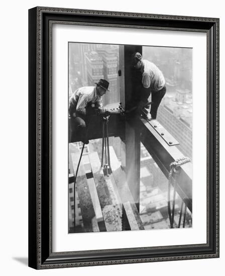 Workers balancing on steel beam above streets during construction of the Manhattan Company Building-Arthur Gerlach-Framed Photographic Print