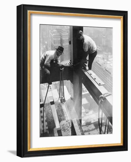 Workers balancing on steel beam above streets during construction of the Manhattan Company Building-Arthur Gerlach-Framed Photographic Print