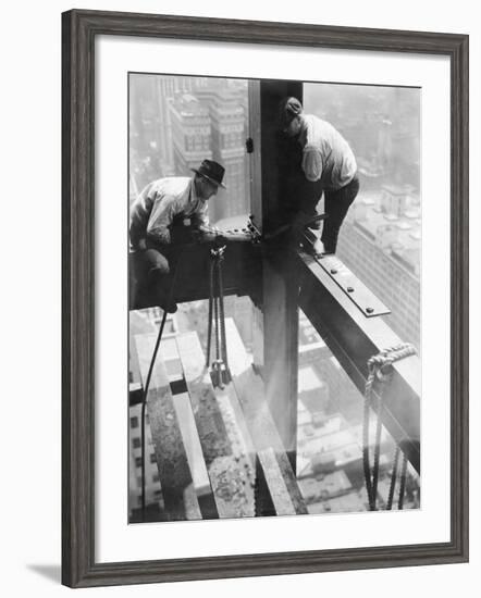 Workers balancing on steel beam above streets during construction of the Manhattan Company Building-Arthur Gerlach-Framed Photographic Print