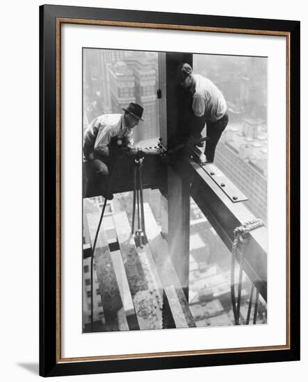 Workers balancing on steel beam above streets during construction of the Manhattan Company Building-Arthur Gerlach-Framed Photographic Print