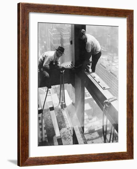 Workers balancing on steel beam above streets during construction of the Manhattan Company Building-Arthur Gerlach-Framed Photographic Print