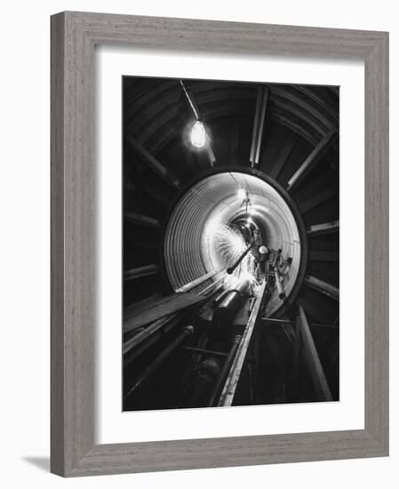 Workers Connecting Sections of Water Pipe in Tunnel-Ralph Crane-Framed Photographic Print