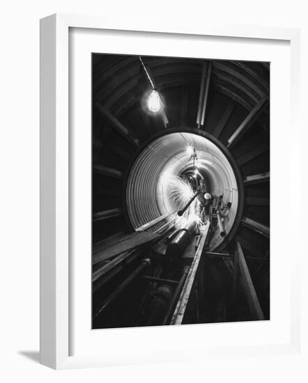 Workers Connecting Sections of Water Pipe in Tunnel-Ralph Crane-Framed Photographic Print