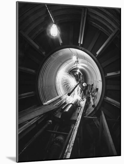 Workers Connecting Sections of Water Pipe in Tunnel-Ralph Crane-Mounted Photographic Print