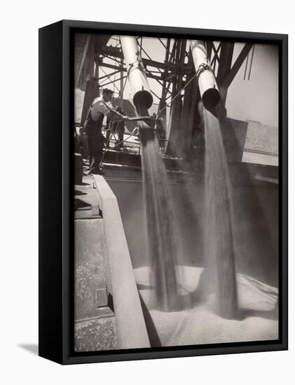 Workers Guiding Granary Filling Spouts as They Pour Tons of Wheat into River Barge for Shipment-Margaret Bourke-White-Framed Premier Image Canvas