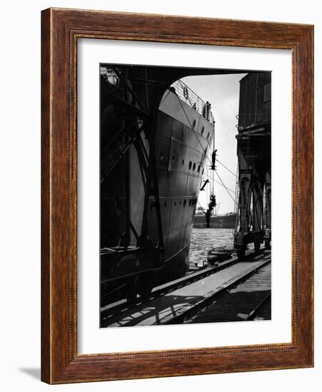 Workers Hanging from Hull of Ship in Hamburg Harbor, in the Midst of Painting It-Emil Otto Hoppé-Framed Photographic Print