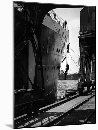 Workers Hanging from Hull of Ship in Hamburg Harbor, in the Midst of Painting It-Emil Otto Hoppé-Mounted Photographic Print